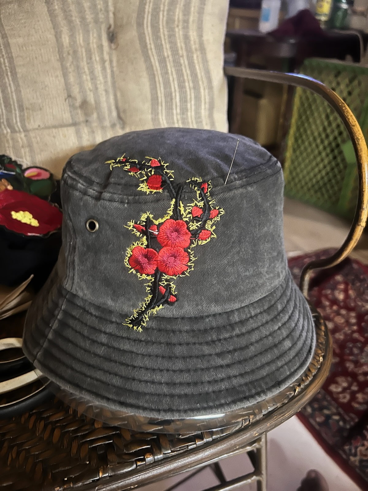 Charcoal bucket hat hand-embroidered with a red cherry blossom branch