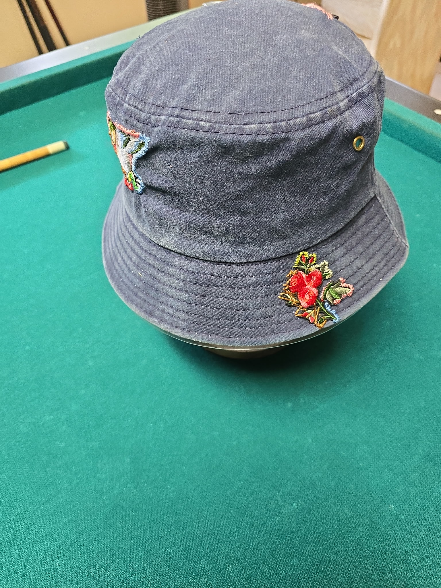 Navy bucket hat hand-embroidered with paired wing and rose designs