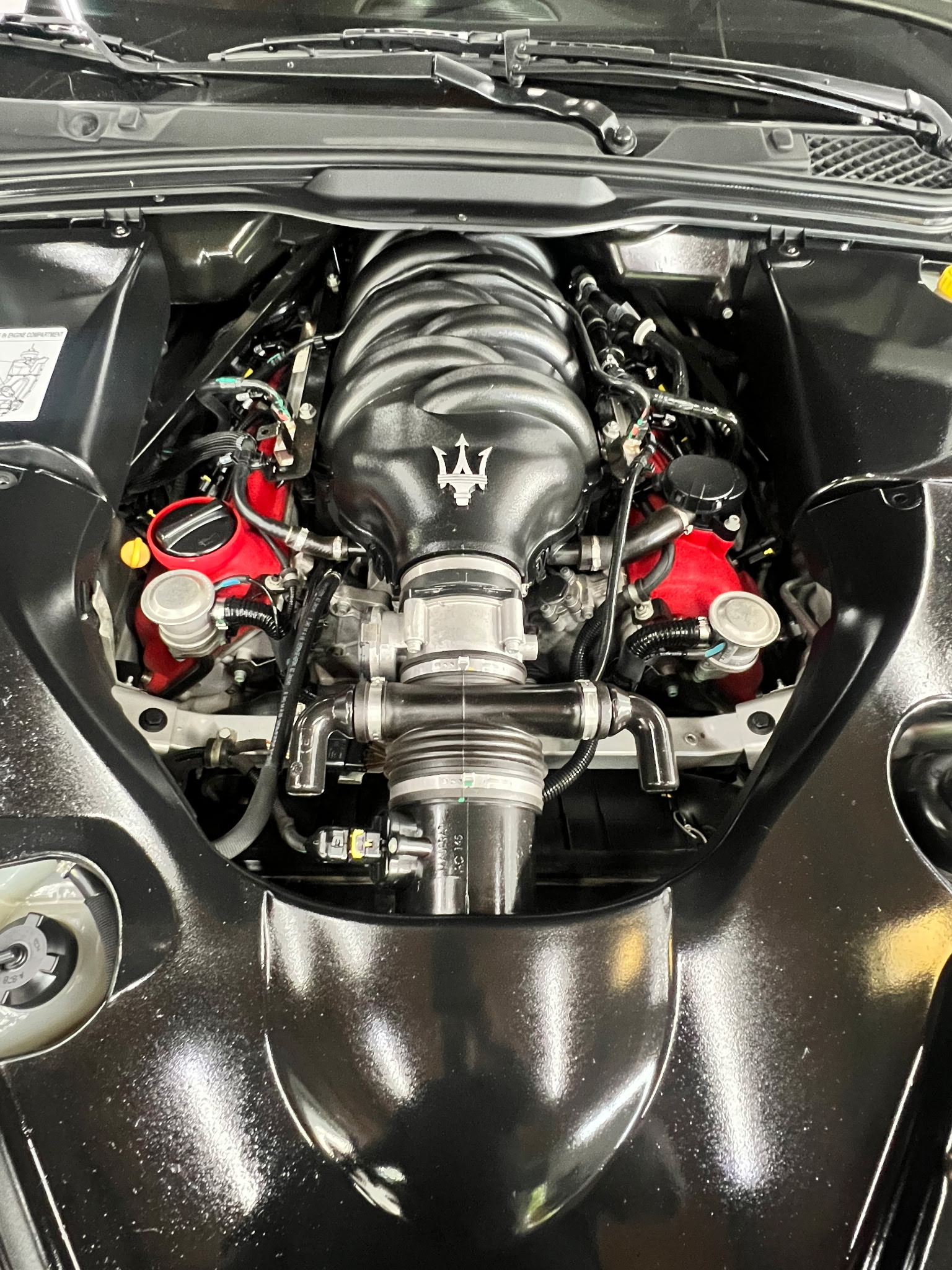 Detail shot of a Maserati engine bay during service at Federation Yard
